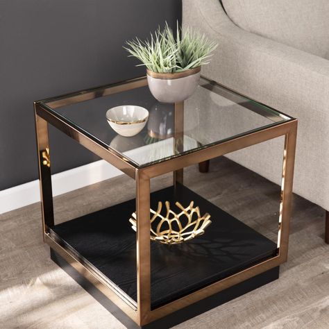 Square side table with glass top. Features 1 spacious display shelf. Inset glass top creates a smooth, seamless feel. Boxy frame and mixed-material construction craft a shadowbox look. Living room or open concept living space. Transitional style. Supports up to: 25-lb (top), 20-lb (shelf). Champagne and black finish. Boston Loft Furnishings Humo Champagne and Black Glass End Table | ATG2045001CK Transitional End Tables, Arm Crocheting, Small End Table, Bedroom Seating Area, Glass Top End Tables, Modern Art Gallery, Glam Living, Living Room Table Sets, Small End Tables