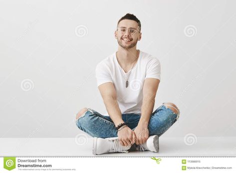 Cute and trendy boyfriend in glasses sitting on floor with crossed legs, holding hands on feet, smiling broadly at. Photo about confident, background, emotional, casual - 113566915 Leg Reference, Guy Sitting, Sitting On Floor, Sitting Cross Legged, Cross Legged, Man Sitting, Human Poses Reference, Human Poses, Character Poses