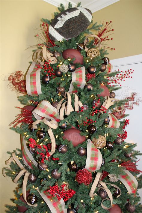 Our latest football themed Christmas tree. We used brown ornaments that we painted to look like footballs, red and gold ornaments, assorted burlap and red picks, adorable ribbon and topped it off with a football sign. We love the finished result. Follow us on Instagram @ksforeverdesigns or visit or website at ksforeverdesigns.wixsite.com/mysite Football Christmas Tree Ideas, Football Christmas Tree, Brown Ornaments, Red And Gold Ornaments, Seasonal Tree, Parade Ideas, Themed Christmas Tree, Football Christmas, Football Signs