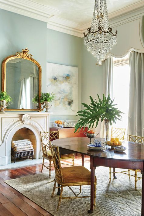 Match History with Glamour - A New Orleans Renovation that Captures History and Charm  - Southernliving. “Sticking with one period, one color, or one style can come across as staid and serious,” says Kaynor. So instead, she plucked feminine pieces from different eras, placing gilt Hollywood Regency chairs alongside 100-year-old marble mantels and a grand crystal chandelier. The wide wooden floors and dark table provide enough old-house seriousness to keep it from looking like a movie set. On the Calming Paint Colors, Greek Revival Home, Decor Eclectic, New Orleans Homes, Decor Shabby Chic, Traditional Dining Room, Dining Room Wall Decor, Room Paint Colors, Room Deco