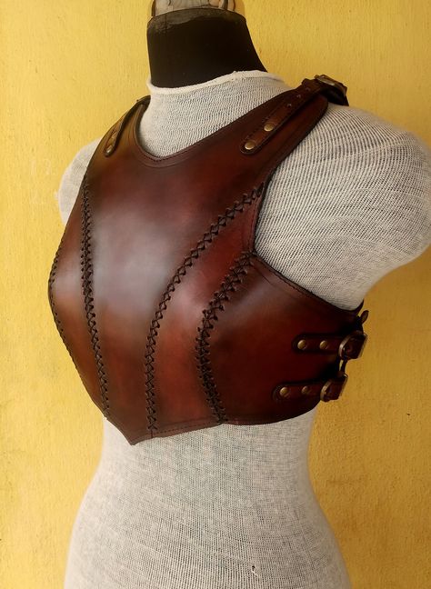 It is handmade leather Renaissance breast plate with hand-sewn leather detailing. It's fully adjustable Top and side with buckles. We used about 2.2 mm thick handmade veg-tan leather. It is hand dyed handmade leather. It is lined with soft leather. Total thickness is 3mm. It is crazy for medieval events and Larp.   It is hand made from sturdy top-grain leather.  Size is available  SM- 30-36" (76- 92cm) ML- 36-42" (92- 107cm) XL: 40-46" (102-117 cm) DETAILS: ► 100% Handmade ► 100% Genuine leather Leather Chest Armor Female, Leather Breastplate Female, Larp Outfit Female, Leather Chest Plate, Leather Fantasy Outfit, Leather Chestplate, Ren Faire Armor, Leather Armor Dnd, Viking Cosplay Female