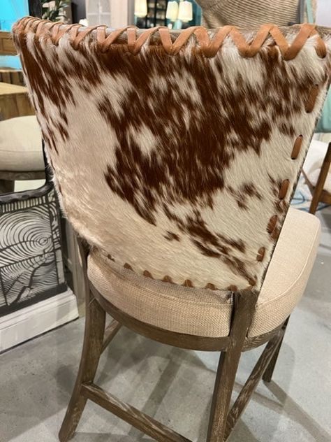 Lina Counter Stool Hair on Hide Set of 3 - Leather back with beautiful lacing and a goat hair on hide on the very back of the Chair. Linen seat bottom. Available in Chair Height also. Neutral in tone, and made visually interesting by the juxtaposition of textures, this striking barstool features a driftwood finish on an oak frame. Combining a hair on hide with varying patterns on the outside back with caramel toned top grain leather, and tying it all together with leather lacing, If a different Western Barstools, Deer Hide Projects, Western Bar Stools, Cowhide Bar Stools, Cabin Living Room Decor, Kitchen Renos, Mocha Mousse, Cowhide Furniture, Cabin Living Room