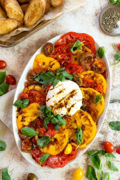 This burrata caprese appetizer recipe is filled with large heirloom tomatoes and creamy cheese. The perfect summer salad, topped with a drizzle of balsamic glaze and a generous drizzle of olive oil. Heirloom Tomato Burrata Salad, Heirloom Tomatoes Recipes, Burrata Caprese Salad, Burrata Caprese, Salad With Burrata, Caprese Recipe, Caprese Appetizer, Gluten Free Recipes Appetizers, Tomato Caprese