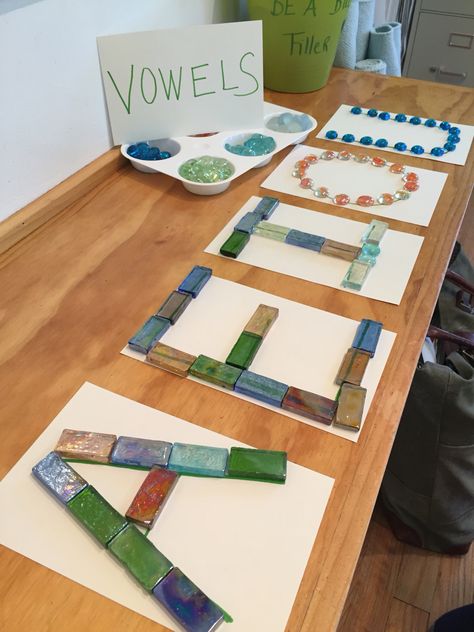 Vowels~ a Reggio Emilia inspiration Reggio Emilia Literacy Activities, Phonics Reggio Emilia, Reggio Emilia Letter Provocations, Reggio Letter Activities, Literacy Centers Kindergarten Reggio, Abordagem Reggio Emilia, Preschool Literacy Centers, Reggio Emilia Classroom, Reggio Emilia Approach