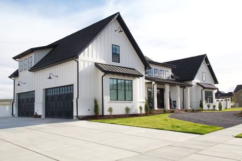 White Farmhouse With White Garage Door, Modern Farmhouse Driveway, White Farmhouse Exterior With Garage, White House Black Garage Door Modern Farmhouse, Modern Farmhouse Exterior 3 Car Garage, Vertical White Siding Modern Farmhouse, White Modern Farmhouse, White Exterior Houses, Vertical Siding