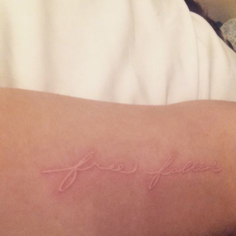 free fallin' white ink tattoo Healed White Ink Tattoo, Free Tattoo Word, White Ink Tattoos, Light Pink Tattoo, White Tattoo Ideas, White Tattoos, Cream Tattoo, One Word Tattoos, Basic Tattoos