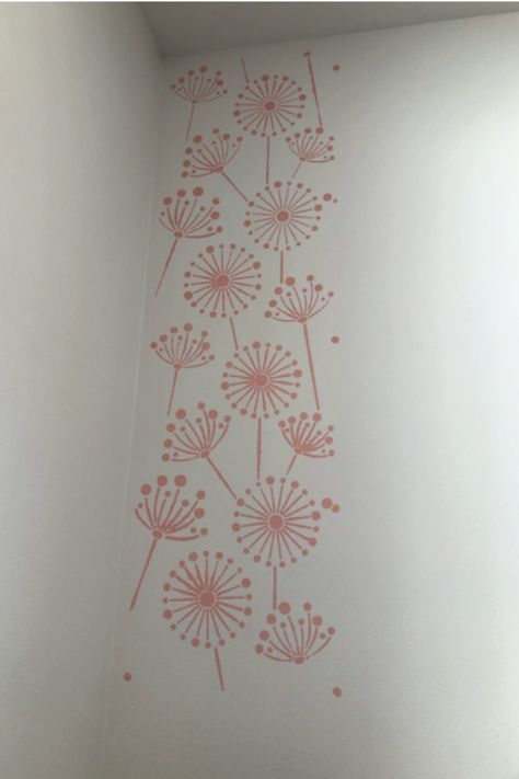 My parents new house is very black and white with little color. My mom ordered a beautiful stencil and asked me to help her add some character to her master bedroom! This stencil wall project is fun, easy, inexpensive and customizable! We used a dandelion stencil, but there are so many stencils and paint colors out there to fit any style! Pink Stenciled Walls, Stencil Accent Wall, Dandelion Stencil, Girls Room Paint, Accent Wall Stencil, Stencil Wall, Diy Wall Painting, A Dandelion, Girl Beds