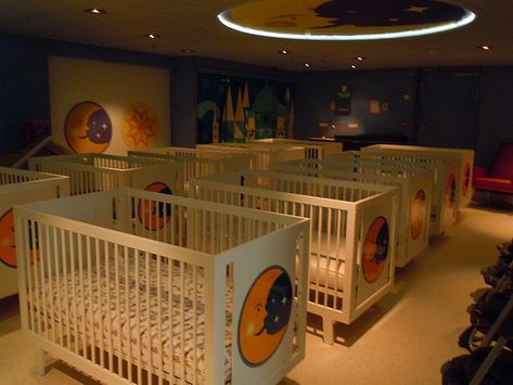 Separated from the play area is a darkened back room with rows of cribs, where sleeping babies will remain under the careful attention of the ship’s staff. Description from insidethemagic.net. I searched for this on bing.com/images Orphanage Ideas, Toddler Daycare Rooms, Daycare Design Ideas, Daycare Room Design, Infant Room Daycare, Sleeping Room Design, Daycare Nursery, Infant Daycare, Daycare Rooms