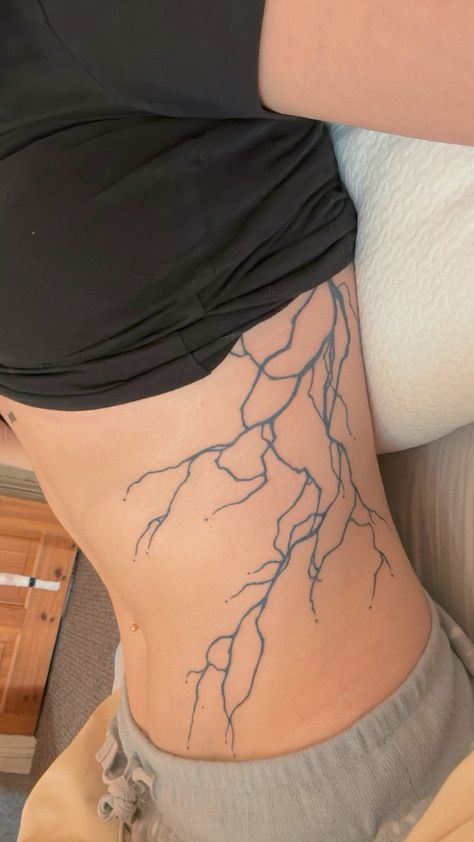 Lightning Tattoo Side Rib, Lightning Side Tattoo, Dragon With Lightning Tattoo, Lightning Tattoo Stomach, Struck By Lightning Tattoo, Lightning Tattoo Women Ribs, Lightning Rib Tattoo, Lighting Strikes Tattoo, Lighting Arm Tattoo