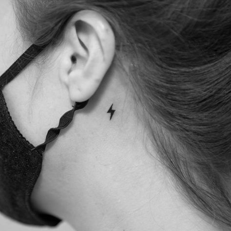 Minimalistic style lightning bolt tattoo done behind Small Lightning Bolt Tattoo Behind Ear, Lightening Bolt Tattoo Behind The Ear, Lightning Bolt Ear Tattoo, Harry Potter Tattoo Behind Ear, Small Lightning Tattoo, Harry Potter Lightning Bolt Tattoo, Lightnight Bolt Tattoos, Lightning Bolt Tattoo Meaning, Thunderbolt Tattoo