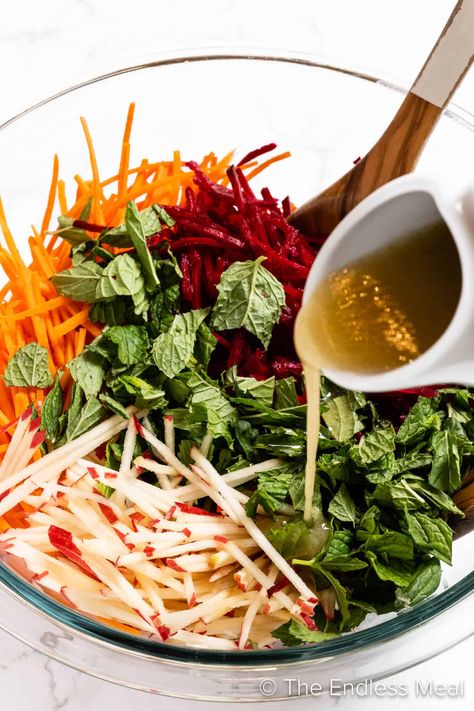 This raw beet salad, loaded with carrots and apples, is a fresh take on coleslaw. The mint and cumin vinaigrette is ridiculously flavorful. This mayo-free side dish is perfect for your summer BBQs and winter dinners alike! #theendlessmeal #salad #beetsalad #rawbeetsalad #sidedish #coleslaw #summersidedish #wintersalad #carrots #glutenfreesidedish #summerrecipes #beets #applerecipe Raw Beet Salad, Best Coleslaw Recipe, Winter Dinners, Ginger Salmon, Apple Salad Recipes, Winter Veggies, Raw Beets, Gluten Free Sides Dishes, Salmon Steak