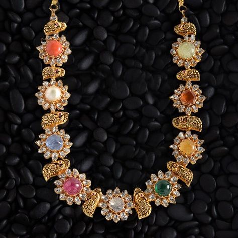 ~ Navratan Haram ~ Nine auspicious stones studded with quality diamonds to make this timeless and gorgeous haram. View this collection at… Navratan Jewellery, Navaratna Necklace, Navaratna Jewellery, Unique Gold Jewelry Designs, Pure Gold Jewellery, Diamond Bracelet Design, Polki Necklace, Bridal Jewellery Indian, Stone Studs