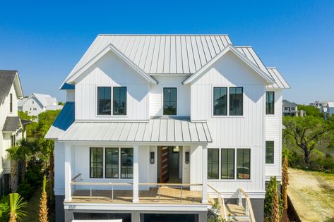 This white home is right on the coast of Daniel Island and Charleston, SC. It's interior and extorior both display a modern look. It is also covered by a dove grey metal roof. Modern Farmhouse With Metal Roof, Beach House Metal Roof, White House White Roof, White House With Metal Roof, White House Metal Roof, Light Metal Roof, White House Grey Roof, Grey Metal Roof, White Metal Roof