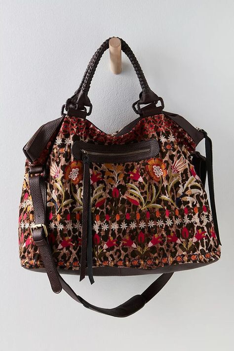 It’s all in the details with this gorgeous floral print Johnny Was overnight bag, purchased at Free People. Features a slouchy style, embroidered floral details, leather trim, braided top handles, adjustable shoulder strap, exterior and interior pockets and zipper closure. New with tags in original Free People plastic bag. This is a stunner! Hundreds of new Free People clothes, shoes an BAGS just listed. Lots of fabulous stuff! Free People Bags, Slouchy Bag, Slouchy Style, Fringe Purse, People Clothes, Carpet Bag, Boho Bags, Leather Bags Handmade, Boho Bag