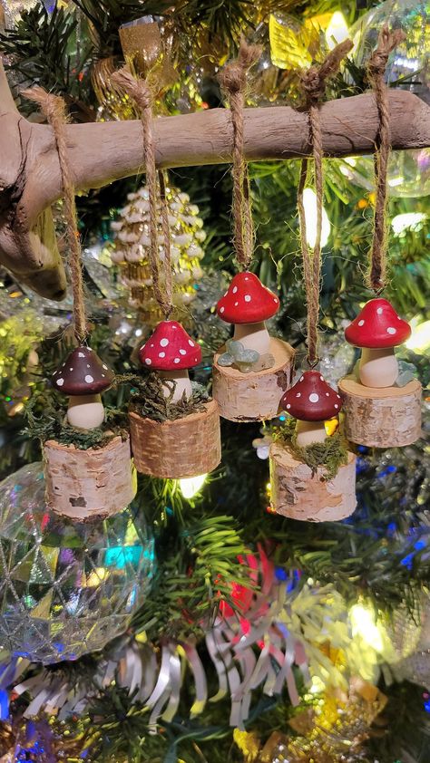 Magical Handemade Mushroom Hanging Ornaments! Set of five hand painted red cap wooden mushrooms sitting on top of a little birch tree stump. Each one is uniquely made. Moss, beautiful green stones and natural birch wood. Each light weight ornament has a hanging hook and pre strung with jute string.  3 × 2 x 2 approx. Birch Christmas Ornaments, Wood Christmas Tree Decorations Wooden Ornaments, Wood Painted Mushrooms, Forest School Christmas Decorations, Mushroom Display Ideas, Decorating With Mushrooms, Woodland Crafts For Adults, Mushroom Ornaments Diy, Diy Mushroom Ornaments