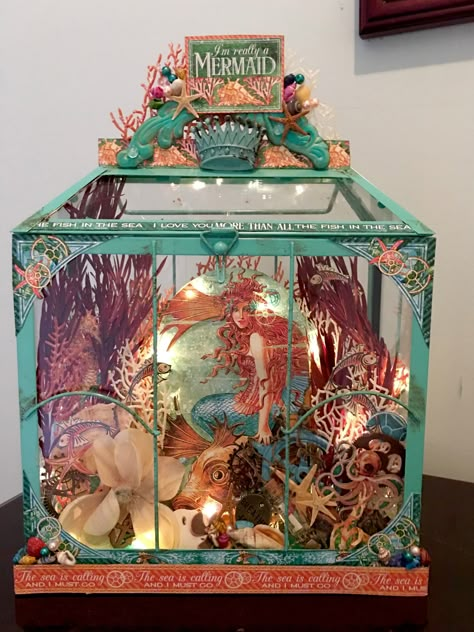 This is a candle lantern that I converted into mermaid display. I added lighting to the inside. Sea Diaroma, Mermaid Diorama, Mermaid Display, Captured Mermaid, Sea Scrapbook, Diaroma Ideas, Seafood Display, Shadow Box Kunst, Paper Diorama