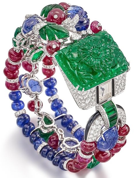 Agrafe Tutti Frutti Bracelet Watch, mechanical movement with manual winding, caliber 101. Rhodiumized white gold case and bracelet set with an engraved emerald of 41.20 cts, 446 brilliant-cut diamonds totaling 4.96 cts, 27 ruby beads totaling 58.16 cts, 26 sapphire beads totaling 39.15 cts, 6 engraved sapphires totaling 34.59 cts, 7 engraved emeralds totaling 18.05 cts, 5 baguette-cut emeralds totaling 0.73 ct and 2 onyx. Unique piece from Cartier's Magicien series. Bracelet Cartier, Cartier Panthere, Ruby Beads, Cartier Jewelry, Gold Jewelry Indian, Tutti Frutti, Fancy Jewelry, Art Deco Jewelry, Diamond Watch