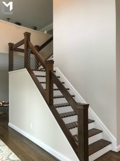 An interior cable railing for these stairs was a really nice touch!  If you're thinking about installing a cable railing and want to know how much it would cost, check out our Custom Quote Builder (https://luxlinematerials.com/custom-quote-builder). Or give us a call (801-899-3806) and we'll make sure you are taken care of from there! Cable Stair Railing, Stairway Railing, Cabin Stairs, Black Flooring, Stairs Diy, Stair Nook, Stairs Railing, Interior Stair Railing, Stair Cases