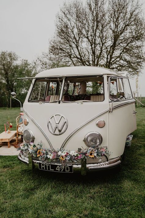 Cream VW vintage campervan wedding transport decorated with colourful flowers on the bumper Vw Camper Wedding, Wedding Campervan, Party Bus Wedding, Wedding Tractor, Vw Bus Wedding, Wedding Vehicles, Coffee Camper, Peonies Wedding Decoration, Vw Wedding