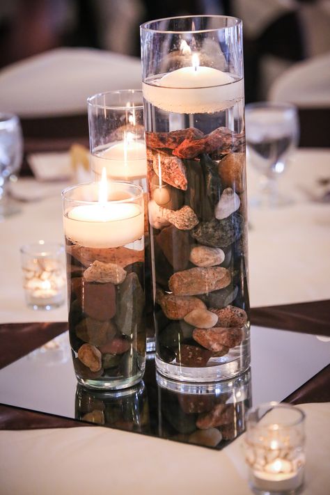 Vases With Rocks Centerpiece Ideas, Rocks And Candles Centerpiece, River Rock Decorating Ideas, Rocks Wedding Decor, River Rock Wedding Decor, Rock Wedding Centerpieces, Stone Wedding Centerpieces, River Rock Centerpiece, Masculine Party Centerpieces