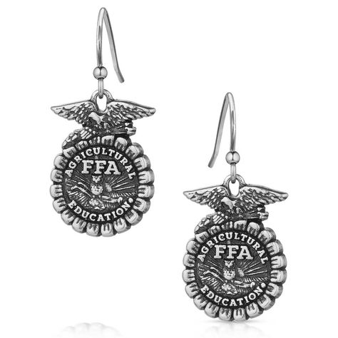 Show your love for the FFA Organization with the FFA Emblem Earrings. The earrings feature an etched FFA emblem in an antiqued silver tone. The earrings depict the FFA emblem in stunning detail. An etched eagle sits atop the cross section of corn. Through the center "Agriculture Education" and "FFA" are clearly visible. The rising sun serves as the backdrop for the plow and owl in the center. These earrings will make the perfect gift to any FFA member, advisor, and alumni in your life. The ... Ffa Officer Gifts, Ffa Teacher, Ffa Emblem, Ag Teacher, Rodeo Jewelry, Country Vibe, Agriculture Education, Cowgirl Aesthetic, Senior Gifts