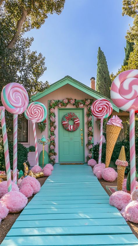 Whimsical front yard with candy-themed decorations, giant lollipops, and ice cream cones, leading to a green door. Christmas Outdoor Candyland, Immersive Christmas Experience, Christmas Candy House Decorations, Candy Cane Wonderland Decorations, Pink Outdoor Christmas Lights, Candy Land Door Ideas, Pink Christmas Porch Decor, Pastel Outdoor Christmas Decor, Gingerbread House Diy Outdoor