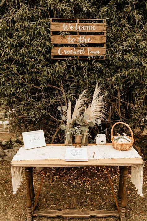 This rustic + boho welcome table features pampas grass and greenery floral pieces | Image by Maya Lora Photo Boho Wedding Signing Table, Boho Guestbook Table, Ceremony Entrance Table, Boho Card Table Wedding, Boho Wedding Guest Book Table, Rustic Wedding Entry Table, Boho Guest Book Table, Boho Guest Table Wedding, Boho Welcome Table