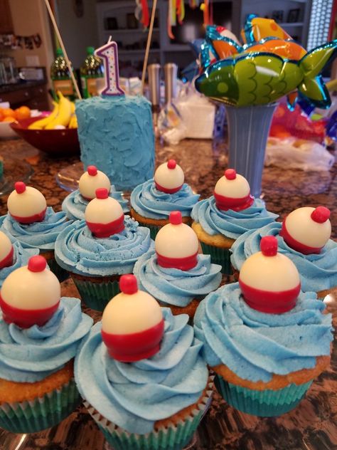 My bobber cupcakes. I used lindt truffles, red melting chocolate, and re rolled starburst candies for the tops. Love how they came out. Bobber Cupcakes, Boys Graduation Party, Lindt Truffles, Fishing Themed Birthday Party, Fishing Cupcakes, Starburst Candy, Fish Party, Cupcakes For Men, Grooms Cakes