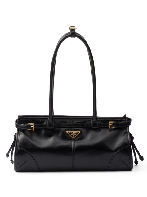 black calf leather smooth grain glossy finish enamel triangle logo seam detailing knot detailing gold-tone hardware concealed top zip fastening adjustable detachable shoulder strap two long top handles internal logo plaque full lining Baguette Bags, Prada Tote Bag, Prada Shoulder Bag, Black Leather Tote Bag, Tote Bag Black, Triangle Logo, Bag Trends, Black Tote Bag, Prada Bag