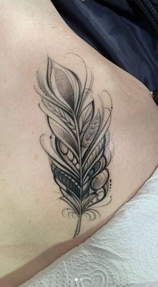 Feather And Moon Tattoo Ideas, Lace Feather Tattoo, Mandala Feather Tattoo Design For Women, Feather Name Tattoos For Women, Indian Feather Tattoo Design, Feather Tattoos On Wrist, Feather Flowers Tattoo, Crown And Feather Tattoo, Egyptian Feather Tattoo