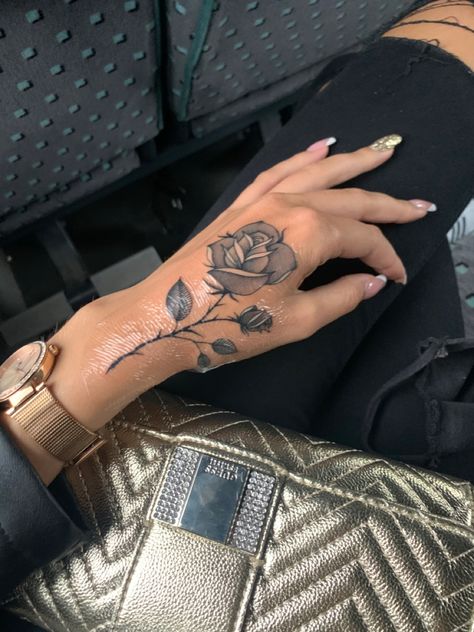 Rose Tattoo On Hand With Name, Rose Tattoos Hand For Women, Flower Tattoo On Top Of Hand, Delicate Flower Hand Tattoos For Women, Side Hand Flower Tattoo, Edgy Leg Tattoos Women, Women Hand Tattoos Ideas Flowers, Small Hand Tattoos Black Women, Rose Tattoo Hand Woman