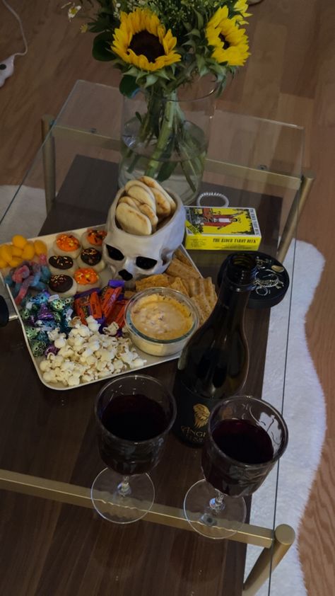 Snack board for date night with halloween cookies, popcorn, dip, pita, skull chip bowl, chocolates, and pumpkin recess. Popcorn Dip, Chip Bowl, Snack Board, Halloween Snacks, Halloween Cookies, Pita, Popcorn, Chocolates, Dip