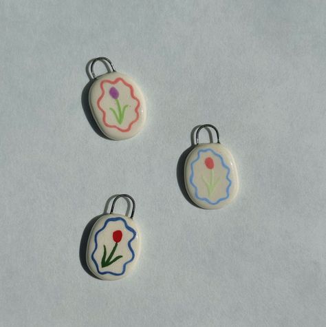 Tiny tulip ceramic charms! These are perfect for charm necklaces, charm bracelets, or anklets. Each charm is handmade and hand-painted from porcelain and pastel glazes to create a unique and adorable keepsake or the perfect present! Please allow for up to 3 weeks for these to be shipped out as each is individually made to order ~This listing is for individual charms. Please choose the charm what the color of jump ring (gold plated or sterling silver) you would like included with your charm.  ~Chains are not included in this listing. Chains may be bought separately through my separate etsy listing. ~Each pendant is handmade from porcelain and glaze and is fired in my kiln twice for optimal durability. *not polymer clay* ~Important Care Instructions~ For the longevity of your charm, avoid ex Polymer Pendant, Porcelain Charms, Polymer Clay Pendants, Ceramic Charms, I Spy Diy, Ceramic Bracelet, Clay Things, Diy Jewlery, Ceramic Necklace