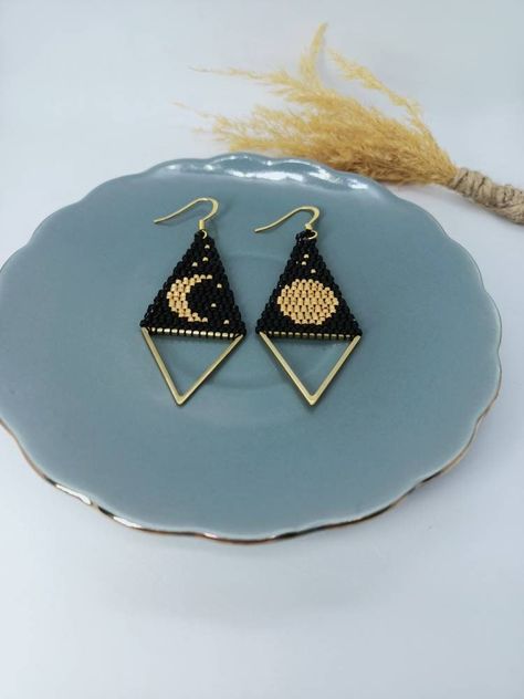 Excited to share the latest addition to my #etsy shop: Beaded Moon Earrings, Diamond Shape Black Gold Earrings, Miyuki Brick Stitch İndigenous Beadwork Jewelry, Folklor Merch Gifts #beadedmoonearrings #miyukibeadsmoon #lunarjewelry #giftsforher #tribaljewelry #diamondshape #frenchhook #gypsyearrings #handmadejewelry #handwoven #brickstitch #indigenousmade #indigenousbeadwork #indieearrings #natureearrings #glassbeads #rush #spaceearrings #women #earlobe #minimalist #earwire #brass #black #gold h Moon Beaded Earring, Triangle Brick Stitch, Brick Stitch Diamond Earrings, Brick Stitch Triangle Earrings, Moon Seed Bead Earrings, Diamond Brick Stitch Earrings, Small Brick Stitch Earrings, Delica Beads Patterns, Miyuki Brick Stitch