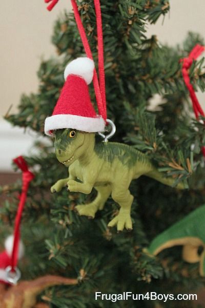 Early on in my boy-raising career, I had to embrace the fact that the boys’ taste in Christmas ornaments is different than mine. Each year, they get to pick out a new ornament for the tree.  It’s a fun tradition, and they are each building their own collection of ornaments.  One of our more memorable … Dinosaur Statue, Toy Dinosaurs, Dinosaur Christmas Tree, Dinosaur Christmas Ornament, Thanksgiving Activities Preschool, Christmas Dinosaur, Thanksgiving Preschool, Preschool Literacy, Activities Preschool