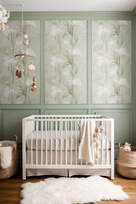 nursery with white crib and fluffy rug on floor. rattan baskets and green accent wall with leaves wallpaper Sage Crib Nursery, Sage Green And Lilac Nursery, Sage And White Nursery, Lavender And Green Nursery, Framed Wallpaper Nursery, Baby Girl Nursery Sage Green And Pink, Boho Baby Room Ideas, Botanical Nursery Girl, Accent Wall Girl Nursery