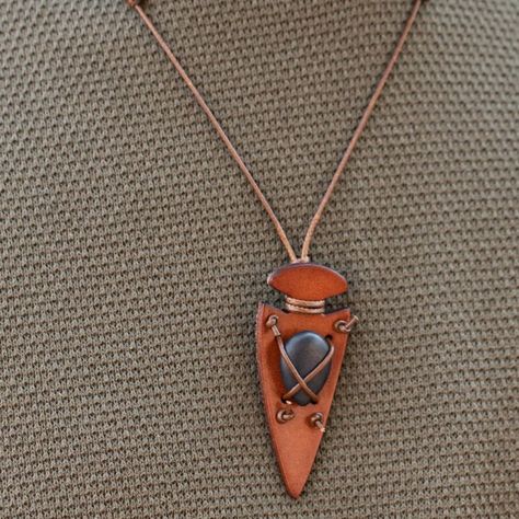 Shiny Brown Cording Crisscrosses Across The Front Of A Refreshing Black Stone, Knotting The Colorful Accent In Place Across The Front Of A Brown Leather Arrowhead Pendant For An Earthy Look. Features An Adjustable Sliding Knot Closure. (1921) Mens Leather Gifts, Wood Jewellery Handmade, Camp Jewelry, Flint Napping, Rocker Necklace, Leather Bracelet Tutorial, Mens Leather Jewelry, Adjustable Sliding Knot, Leather Inspiration