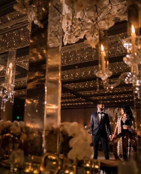 Stunning South Asian / Indian wedding. Glimmering gold black tie with orchids. + Vendors:  Bride: @missrocky08 Photo: @Andrewkwakphoto  Venue: @hyattregencylongbeach Video: @onetake_timmy Makeup:@dolledupbylulu Planner:@bel_events Mendhi: @desairachna Designer: @miss.kismet Black And Gold Wedding Aesthetic, Gold And Black Wedding Reception, Indian Wedding Reception Backdrop, Black And Gold Reception, Black Indian Wedding, Black Gold Wedding Theme, Pink Indian Wedding, Gold Indian Wedding, Asian Wedding Venues