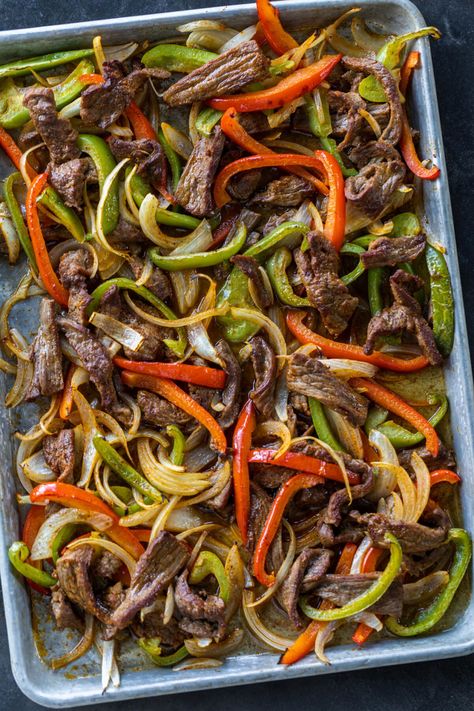 Tender steak strips, peppers, and onions come together in this sheet pan steak fajitas dinner. Get ready for a "fiesta" of flavors that'll make your tastebuds dance! Fajitas Dinner, Sheet Pan Steak Fajitas, Fajita Night, Sheet Pan Steak, Pan Fajitas, Pan Steak, Homemade Fajita Seasoning, Shrimp Fajitas, Sheet Pan Dinners Recipes