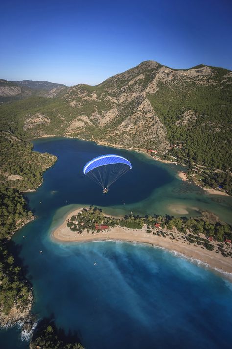 A paraglider flying over Turkey's Ölüdeniz Beach ©  Danita Delimont / Getty Images Paragliding Photography, Volkswagen Van, Toronto City, Photography Sky, Italy Travel Guide, Instagram Photo Ideas Posts, Work Travel, Travel Inspo, Lonely Planet