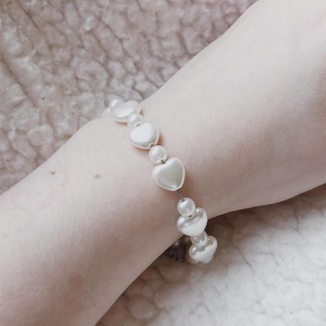 Pearl heart bracelet 🤍 🛍️ link in bio to shop my etsy 🛍️ 🏷️Get 25% off your entire order when you purchase 3+ items! Automatically applied at checkout! shop my etsy with this link https://needfulthingsthrift.etsy.com handmade jewelry accessories, ethereal, delicate, statement, nature-inspired, unique, artisan, custom, handcrafted, one-of-a-kind, boho, minimalist, vintage-inspired. gemstone, dainty, modern, tribal, pearls, crystals, crystal beads, charm bracelet, hippie, witchy, charms, ... Witchy Charms, Minimalist Vintage, Beads Charm, Boho Minimalist, Pearl Heart, Needful Things, Heart Bracelet, Nature Inspired, Crystal Beads