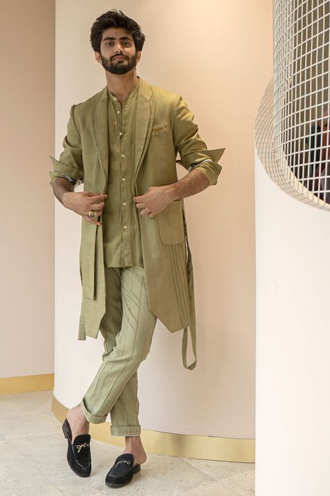 Featuring a sage green overcoat in a cotton linen base. It is paired with a matching belt.  FIT: True to size. COMPOSITION: Cotton linen. CARE: Dry clean only Indian Wedding Outfits For Men Classy, Engagement Outfits Indian, Sangeet Outfit For Men, Indo Western Outfits For Men, Green Overcoat, Jatin Malik, Indo Western Dress For Men, Indian Wedding Suits Men, Mens Traditional Wear