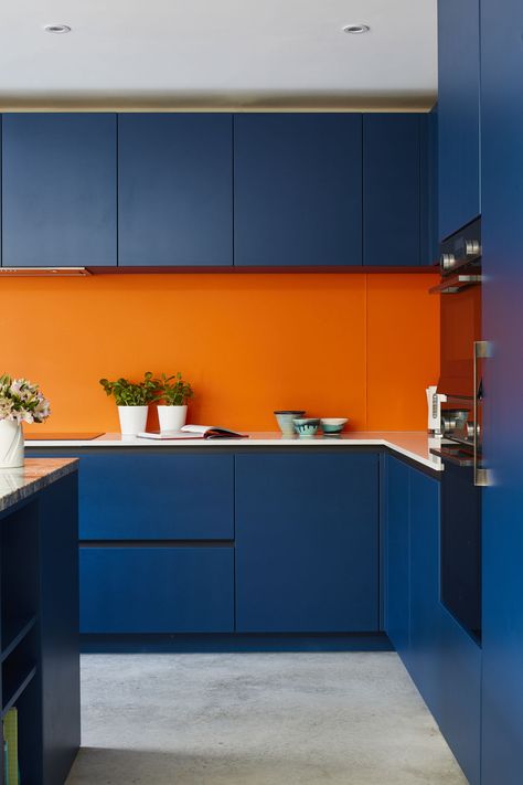 Stunning blue and orange colours for this kitchen extension with Azzurite quartzite worktop on the Island, and the concrete floor.   We are an independent kitchen company that can help you design and create your perfect bespoke kitchen. #kitchendecor #kitchendesign #kitchenideas #quartziteworktop #concretefloor Orange And Blue Kitchen Ideas, Orange Blue Kitchen, Navy And Orange Kitchen, Orange And Blue Interior Design, Dark Orange Kitchen, Blue And Orange Interior, Blue And Orange Kitchen, Orange Kitchen Cabinets, Bright Blue Kitchen