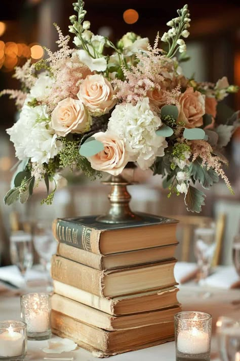 17 Enchanting Hydrangea Centerpieces • Book Decorations For Wedding, Vintage Books Centerpiece, Education Themed Centerpiece, History Themed Centerpieces, Book And Flower Centerpiece, Elegant Bridal Shower Centerpieces, Light Academia Wedding Theme, Castle Wedding Centerpieces, Books For Table Decor