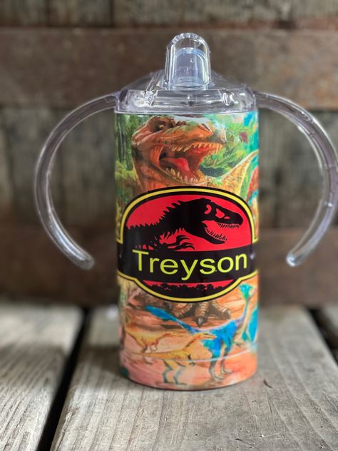 This jurassic park tumbler will keep kids drinks cold for hours! The personalization option is perfect for kids in daycare!! Shelbyville Tennessee, Kids Drinks, Sippy Cup Tumbler, Kid Drinks, Sublimation Tumblers, Cup Tumbler, Sippy Cup, Jurassic Park, Beer Steins