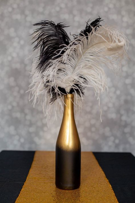 These DIY Gatsby party centerpieces are awesome! I love the ones made with ostrich feathers and the champagne glass tower. A perfect addition to my roaring 20s party decor. #entertainingdiva #roaring20s #gatsbywedding #centerpieces #partydecor #diypartydecor 1920s Holiday Party, Roaring 20s Centerpieces Diy, 20s Decorations 1920s Party, 1920s Centerpieces Roaring 20s, Diy Gatsby Party, Gatsby Centerpiece Ideas, Great Gatsby Centerpiece, Great Gatsby Centerpieces, Roaring 20s Prom Theme