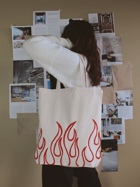 "Hand-painted \"flame\" design tote bag. A perfect accessory to spice up an everyday outfit. DETAILS: 16\" H x 15\" W x 21\" Handle and 3\" Gusset Like this item? Check out our website: https://www.dzaehelladreams.com/" Gift For Her Ideas, Tod Bag, Diy Bag Painting, Diy Tote Bag Design, Handpainted Tote, Painted Canvas Bags, Handpainted Tote Bags, Desain Tote Bag, Totes Ideas