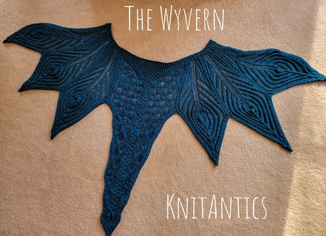 A Wyvern is a Welsh dragon that is nearly extinct in the wild.  Conservation efforts have stabilized the population on the remote island of Ynis Monstrys. Tourists are not allowed as they would be eaten with ketchup. This knit pattern grants the wearer the ability to RAHR! at all passersby with impunity.   This pattern requires approximately 600 y of yarn, size 7 straight and circular needles, or the needle size to match your yarn. I recommend DK to Aran weight yarns.  This is a fairly intricate design for the brave of heart, worthy of dragonhood.  Bunny constructed the original version in the silk spun by the fabled Bombyxmori Tribe of Shangri-La. I've added an updated version to augment the original files, labeled TheWyvern_020224. If you run into any problems, get stuck along the way, o Dragon Shawl Knitting Pattern, Knit Dragon Pattern Free, Dragon Knitting Pattern, Crochet Dragon Wings, Celtic Knitting Patterns, Alternative Knitting, Knitting Scarfs, Knit Cowl Pattern, Modern Knitting Patterns