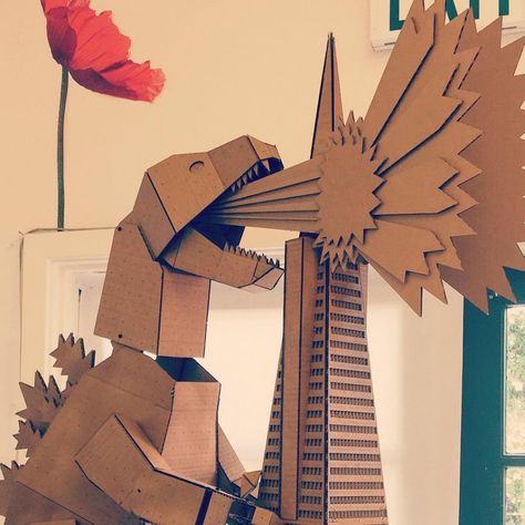 Fire breathing cardboard Godzilla demolishing a building at the Easthellip Godzilla Valentines Day Boxes, Godzilla Valentine Boxes For Boys, Godzilla Room, Godzilla Decorations, Dinosaur Diy, Godzilla Party, Godzilla Birthday Party, Godzilla Birthday, Paper Tea Cups