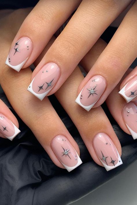 Channeling celestial beauty with French Tips adorned in delicate star constellations, this dreamy manicure combines a soft pink base with minimalist silver designs. The sparkling accents add a touch of enchantment to create a perfect, starry night-inspired look. // Photo Credit: Instagram @glamnails_bymeg Chrome Nail Ideas, January Nail, January Nail Designs, Star Nail Designs, Silver Nail Designs, Ring Finger Nails, White Tips, Chrome Nails Designs, Subtle Nails